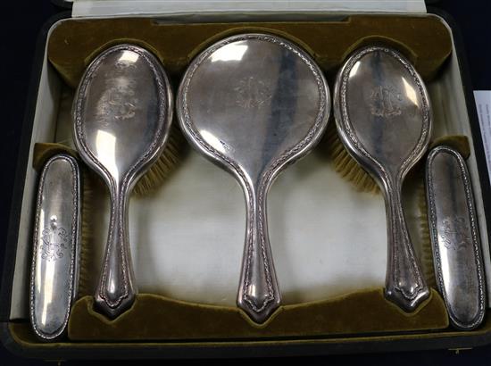 A cased George V silver five piece mirror and brush dressing set, Walker & Hall, Sheffield, 1918, in Walker & Hall box.